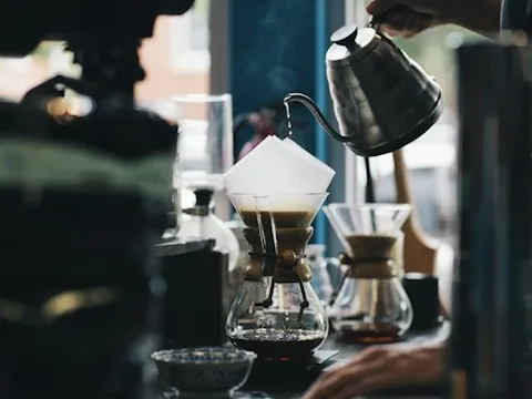 Pour-over coffee being made beside a window